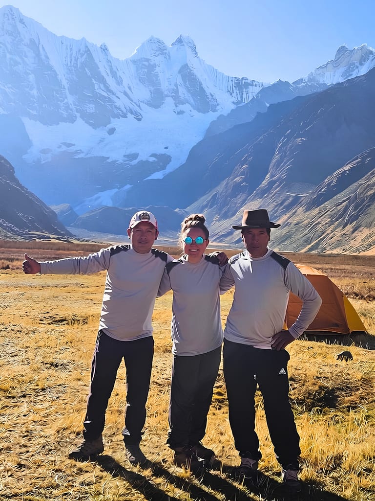 Cordillera Huayhuash trek guides and camp crew below the snow peaks of the range